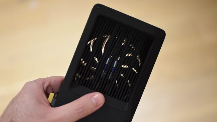 A view of the the Intel Arc B580's cooling fan through its exposed radiator.