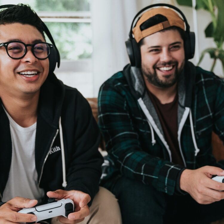 Two people playing video games and smiling.